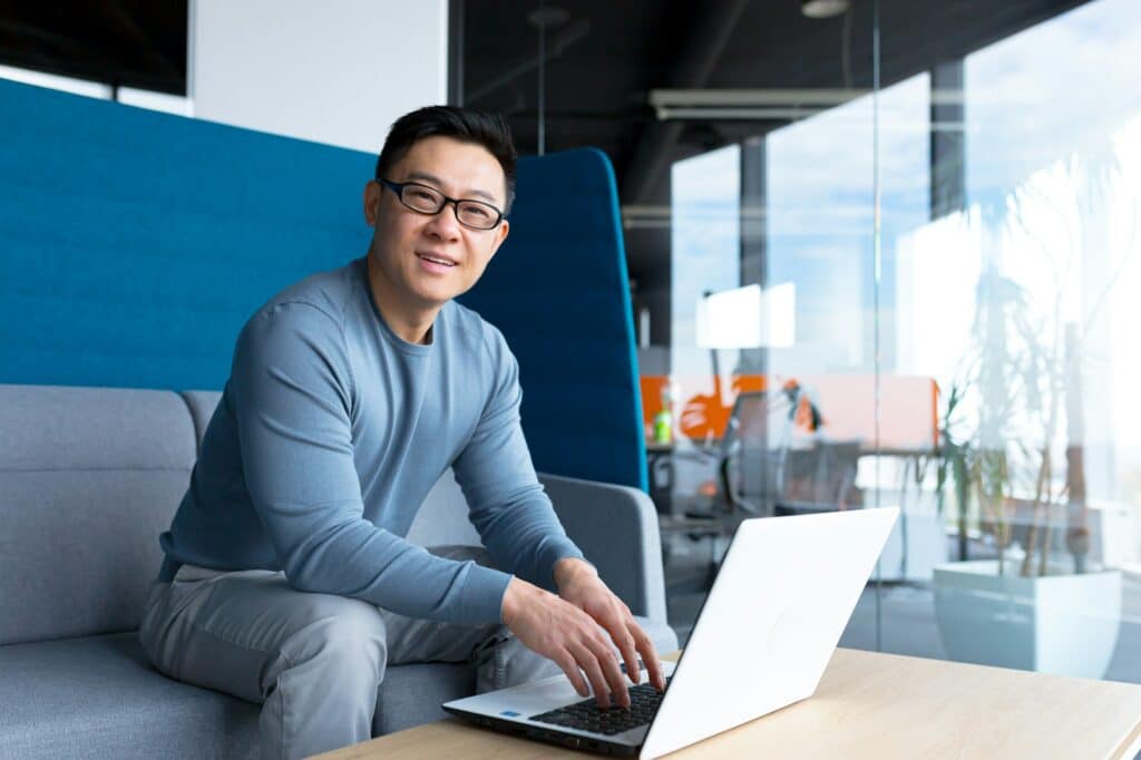 Eager real estate agent looking up details on his computer about how to join ARIVL Real Estate.