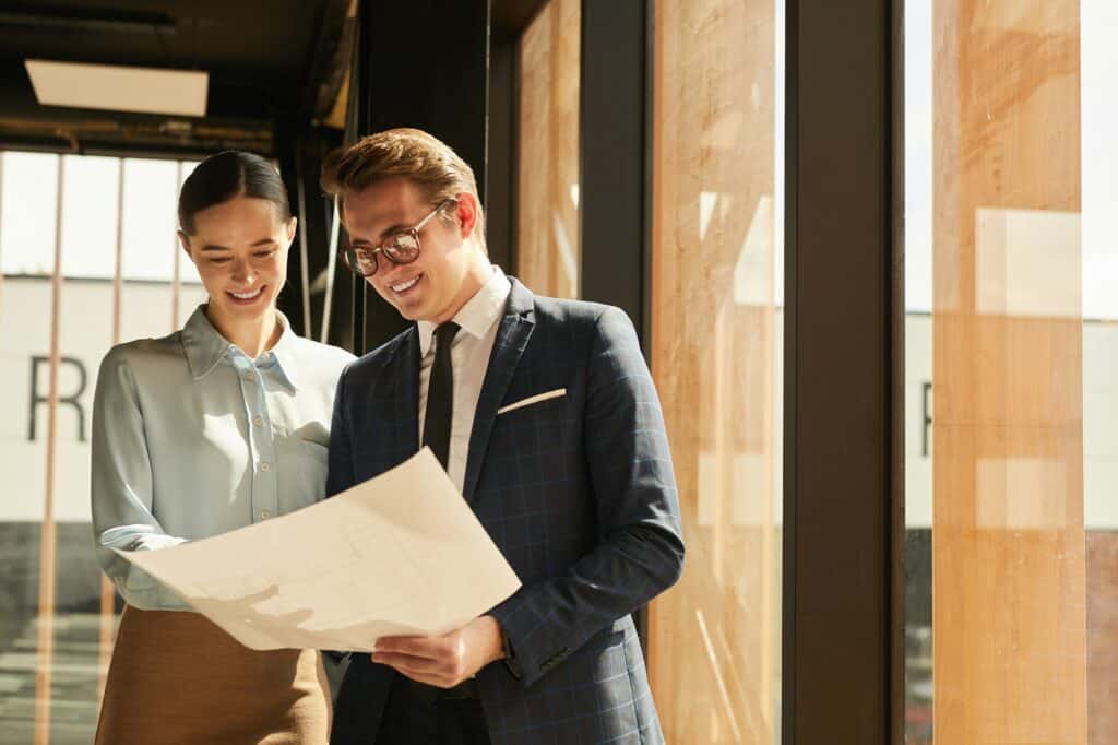 Real Estate Agent Showing Plans to Client